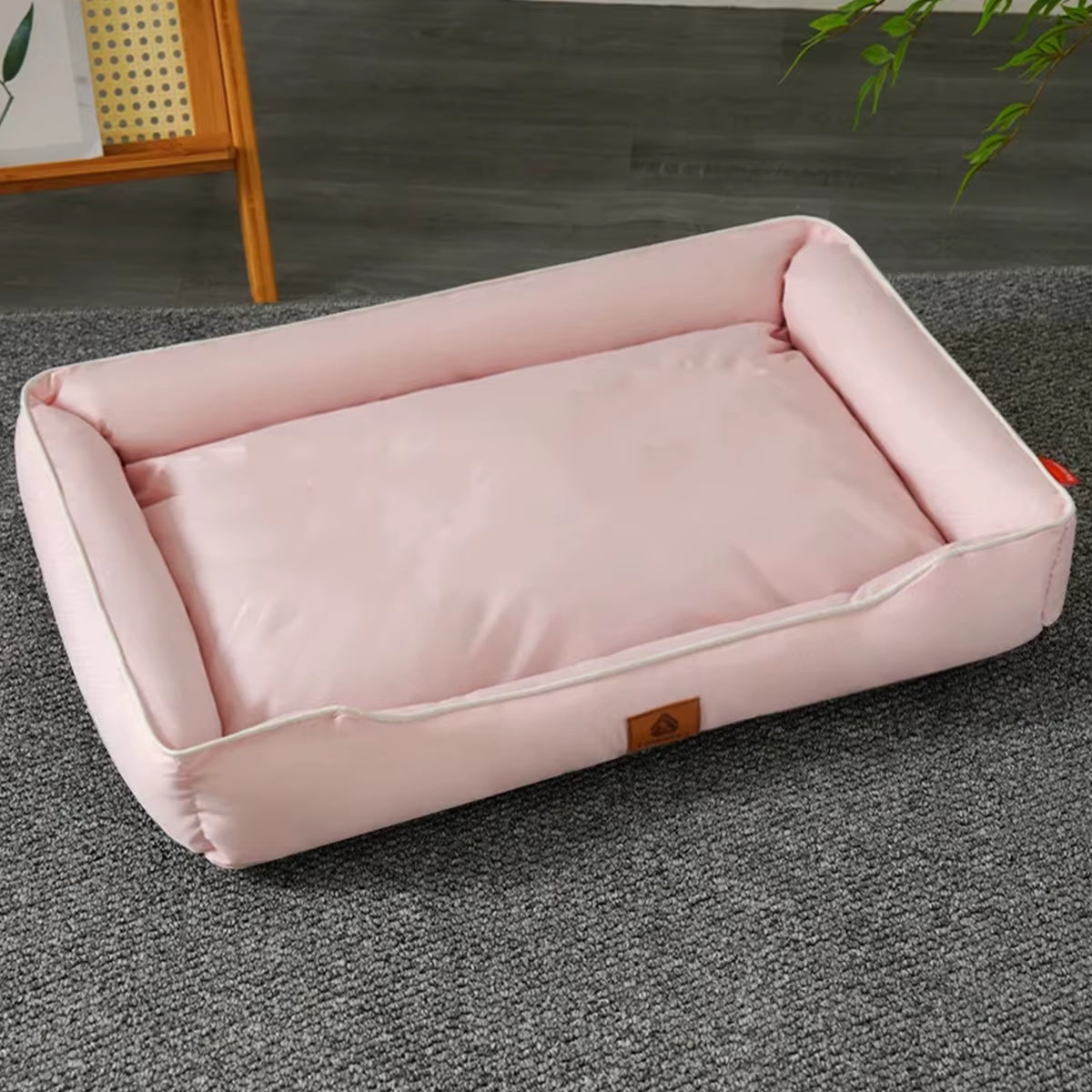 Four Season Square Dog Bed in soft pink color with padded edges for pet comfort and support.